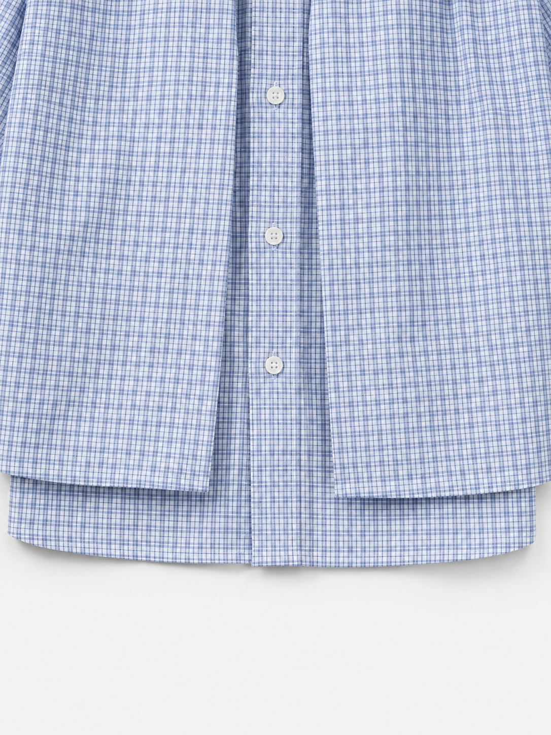 Sunday Check Shirt in Light Blue. Close-up of the button front, double-layer hem, and micro-check fabric.