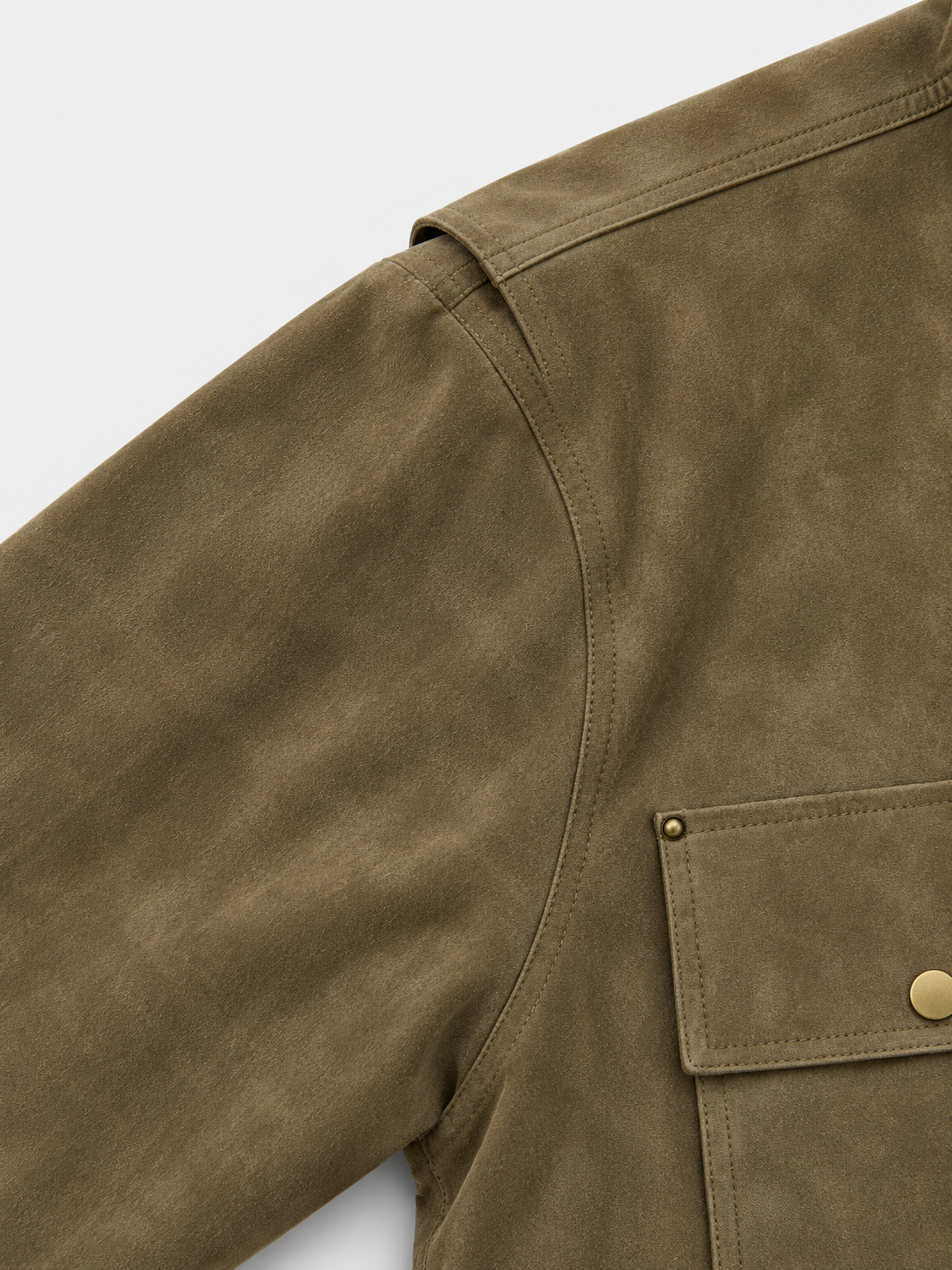 Legacy Trucker Jacket in Military Green. Close-up of the shoulder seam and flap chest pocket.