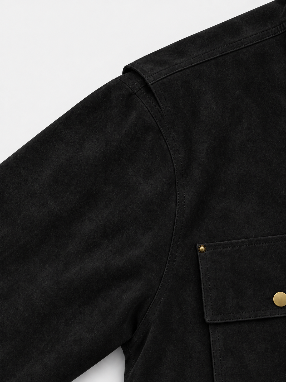 Legacy Trucker Jacket in Jet Black. Close-up of the shoulder seam and flap chest pocket.