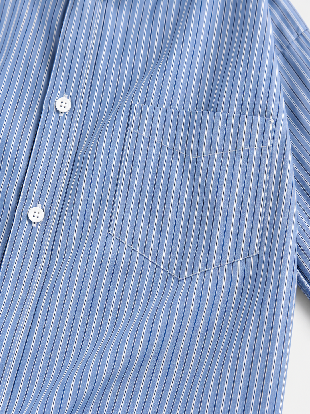 Sterling Stripe Shirt in Sterling Blue. Product-only detail showing the fine vertical stripes, white button placket, chest pocket and stitching.