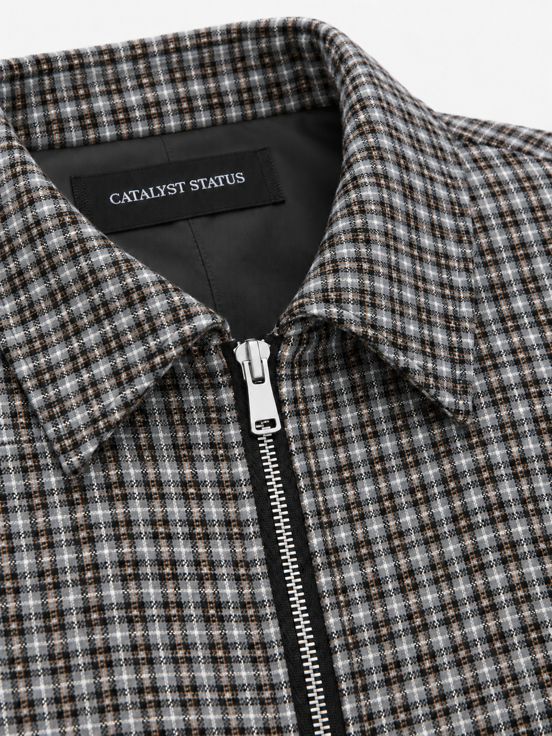 District Check Jacket in Graphite. Close-up of the pointed collar, front zipper, and Catalyst Status label.