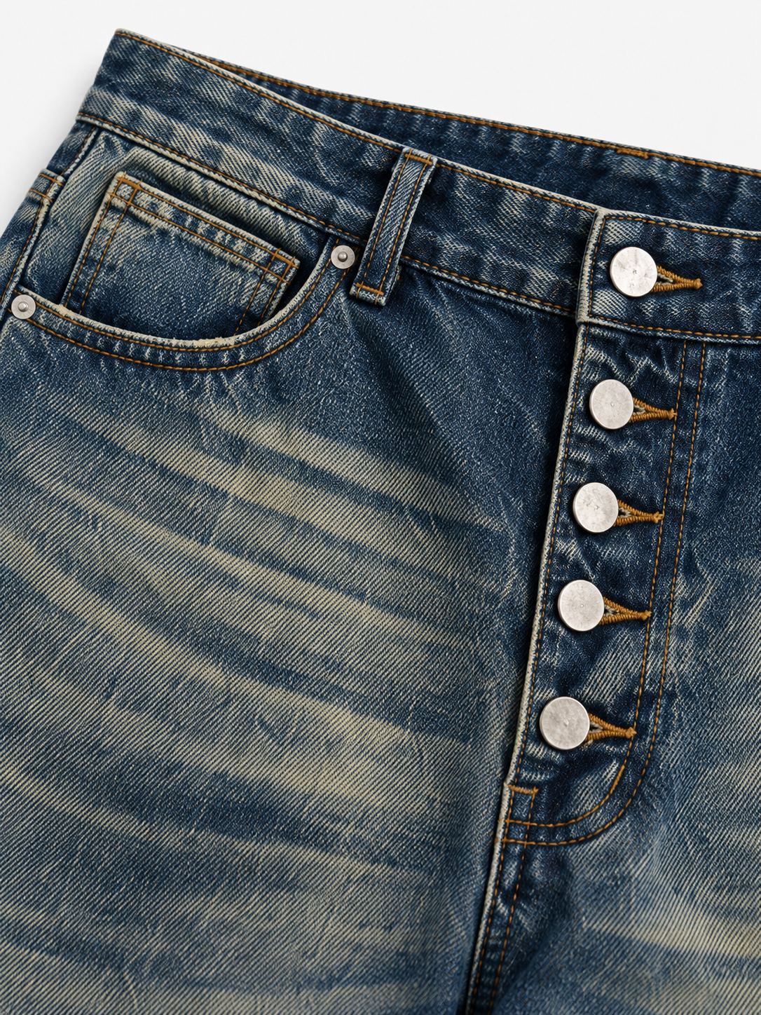 Button Fly Baggy Jeans in Iron Indigo. Close-up of the exposed metal button fly and front pocket.