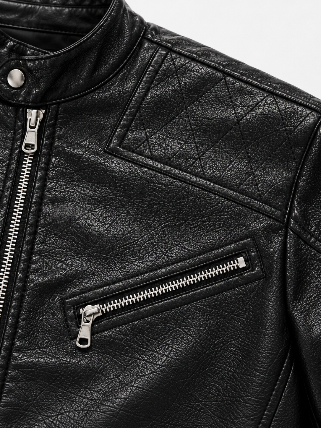 Aegis Leather Jacket in Gloss Onyx. Close-up of the snap collar, quilted shoulder panel, and chest zipper.